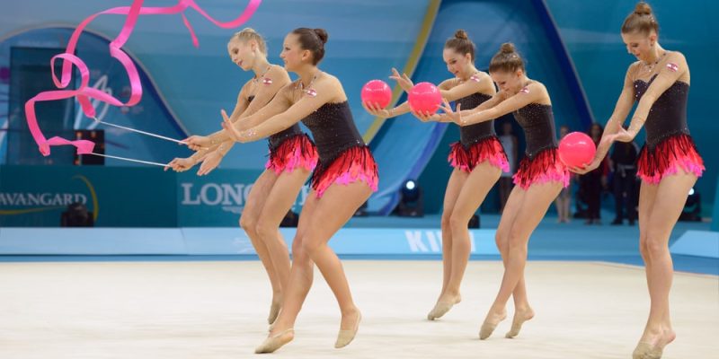 Chica haciendo gimnasia rítmica con mazas.