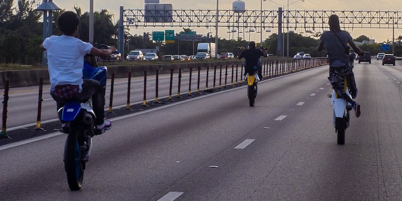 Un grupo de jóvenes conducen sus motocicletas en la autopista con temeridad.